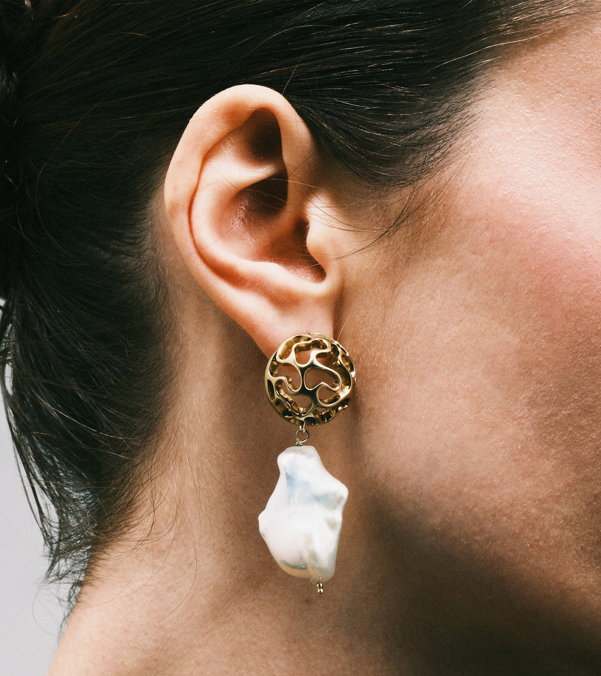 AION Pearl Earrings in gold vermeil worn on the ears