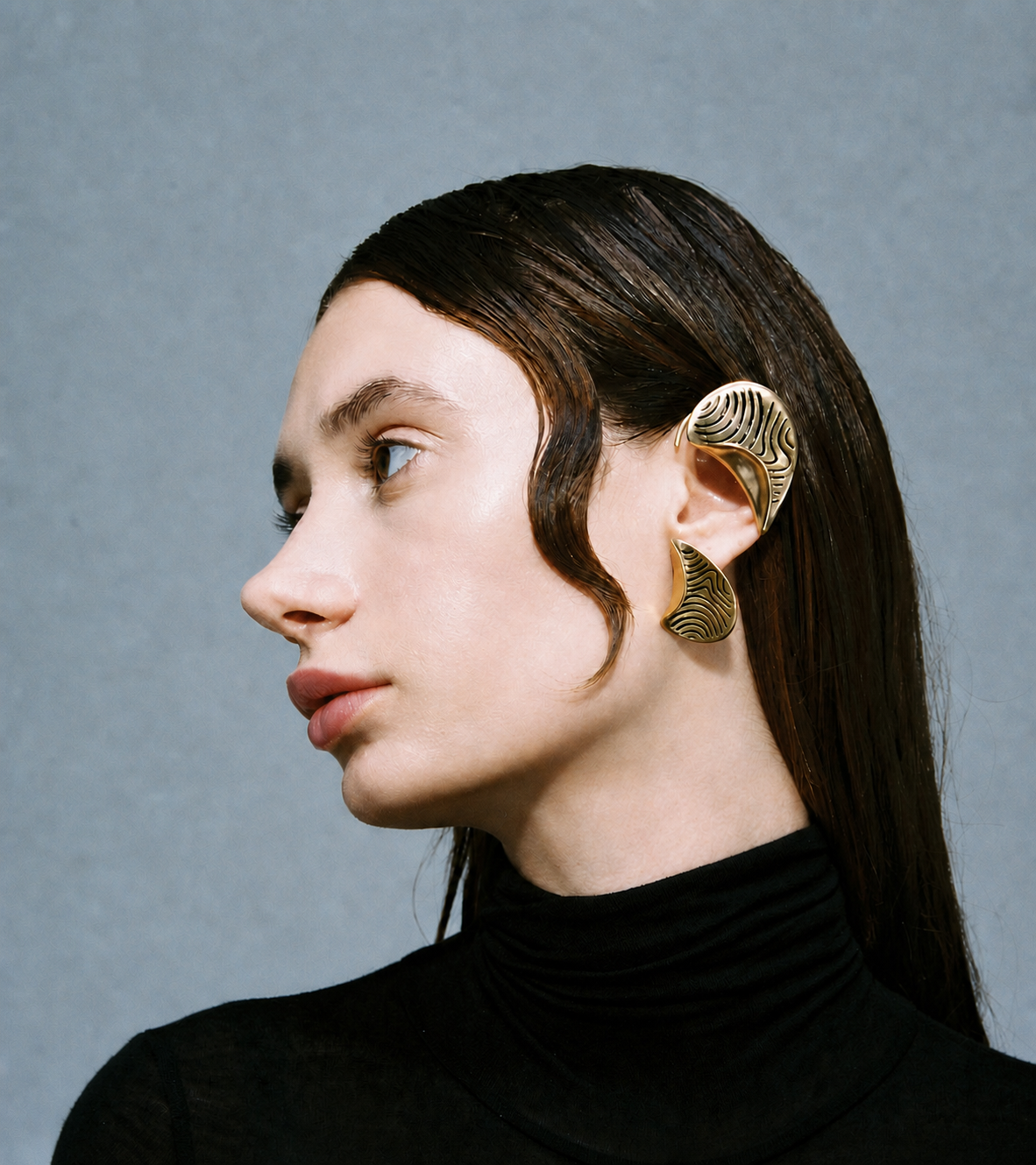 FOLD Ear Cuff in 18k gold vermeil shown on the left ear