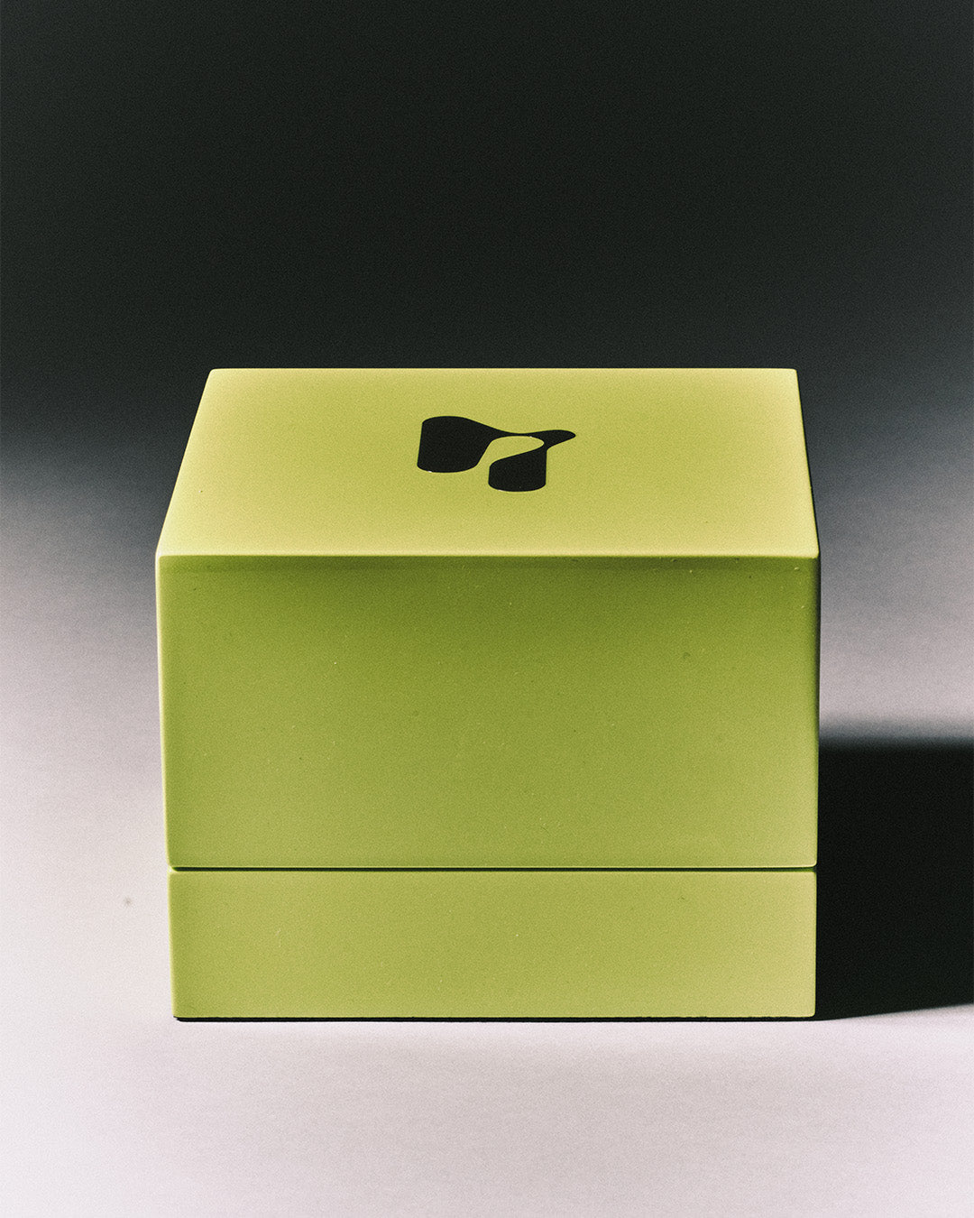 Lime green Nowar jewelry box with the studio logo on its lid
