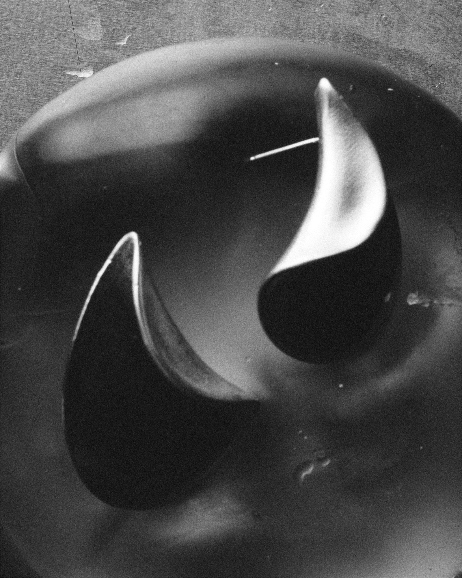 Black-and-white still life of FOLD sculptural silver earrings