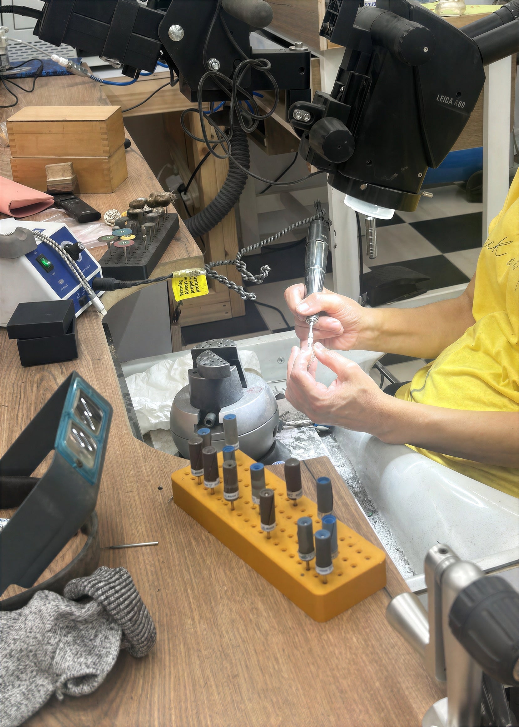 Finishing a jewelry piece by hand at the studio workbench