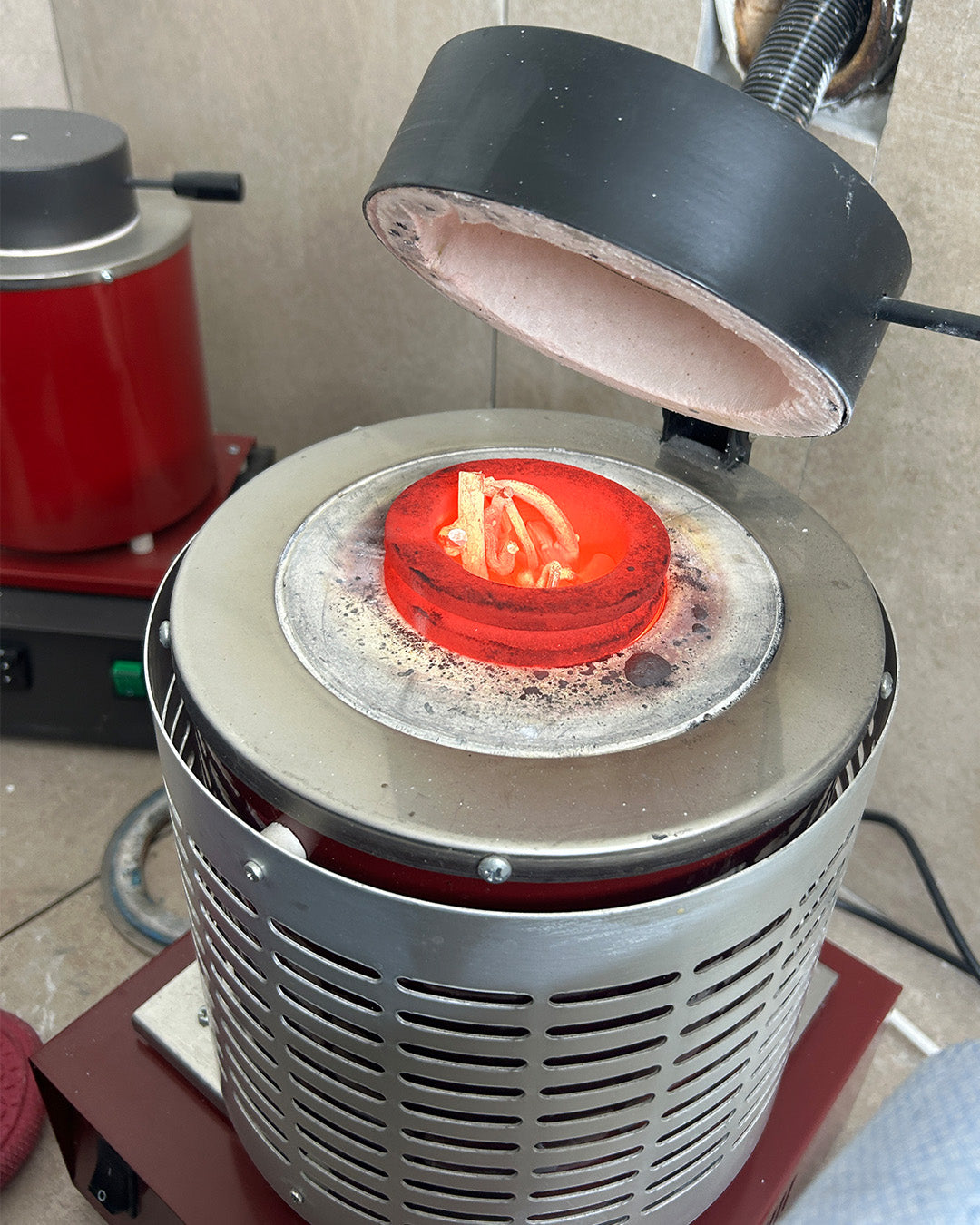 Glowing metal inside the studio casting furnace